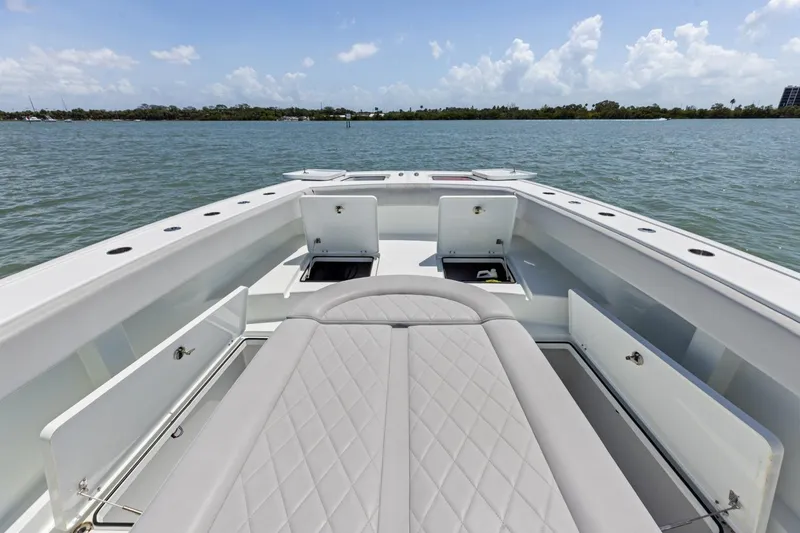 Slide: The Image of Luxurious 2020 Freeman 42LR boat interior with open storage compartments on calm water. - 34