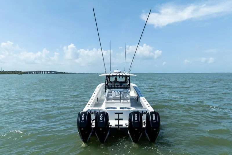 Slide: The Image of Freeman 42LR 2020 boat with quad engines on open water, clear sky background. - 4