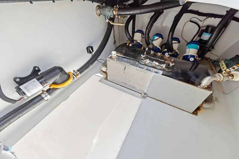 Slide: The Image of Engine compartment of a 2020 Freeman 42LR boat, featuring hoses and a metal tank. - 44