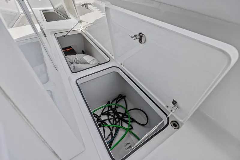 Slide: The Image of Open storage compartments on a 2020 Freeman 42LR boat deck. - 47