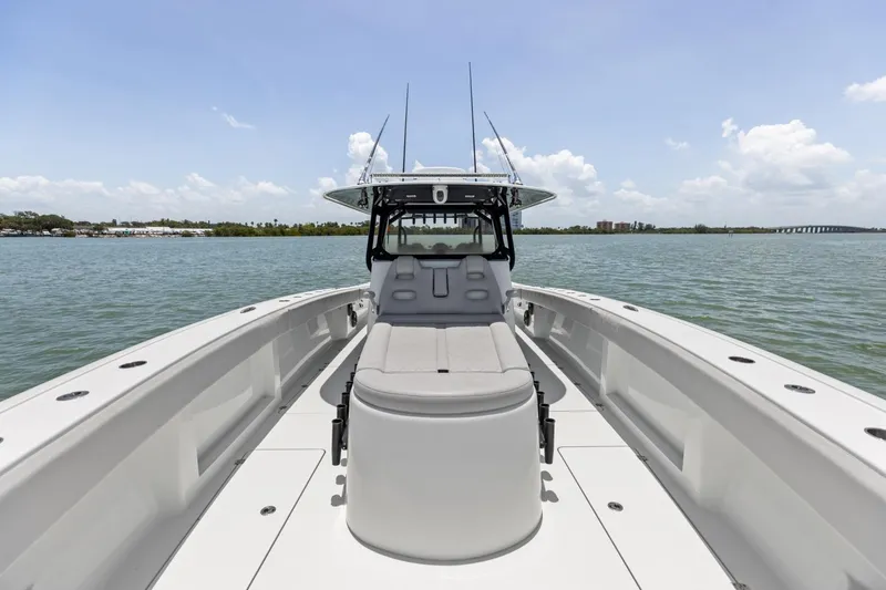 Slide: The Image of 2020 Freeman 42LR boat on calm water, showcasing spacious deck and seating. - 53