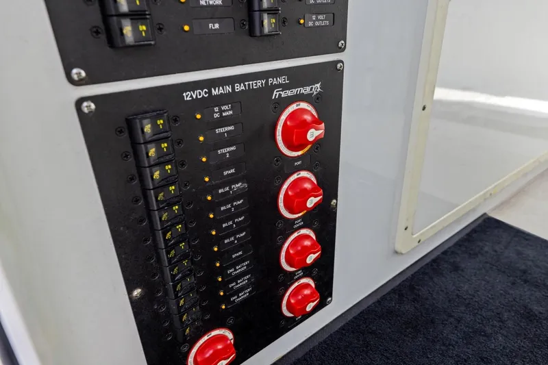 Slide: The Image of 12VDC main battery panel on 2020 Freeman 42LR boat, featuring switches and controls. - 58
