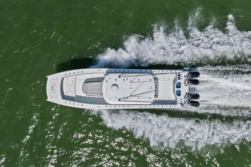 Slide: The Image of Aerial view of 2020 Freeman 42LR boat speeding on green water. - 8