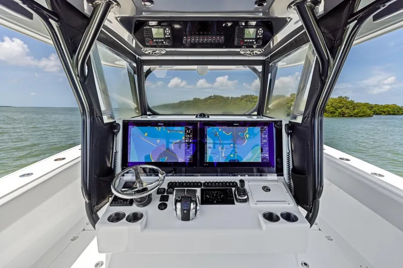 Slide: The Image of Cockpit of 2020 Freeman 42LR boat with navigation screens and steering wheel. - 9