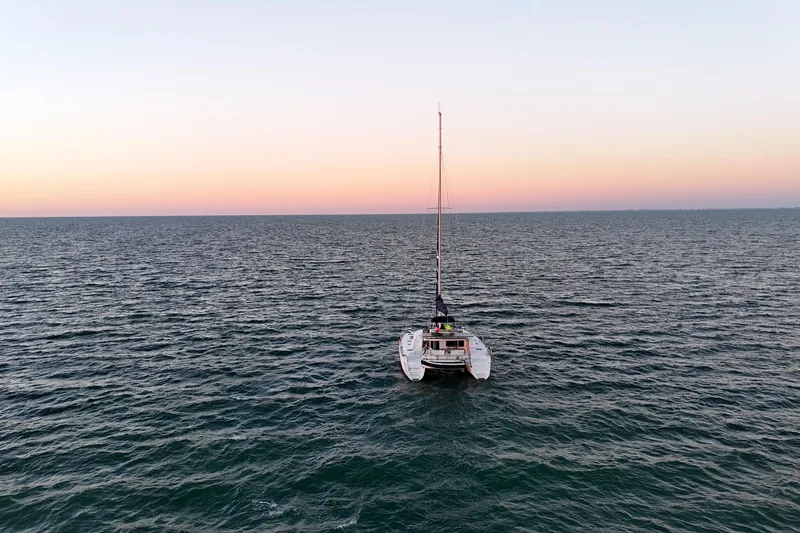 Slide: The Image of Lagoon 440 catamaran 2009 sailing at sunset on open sea. - 3