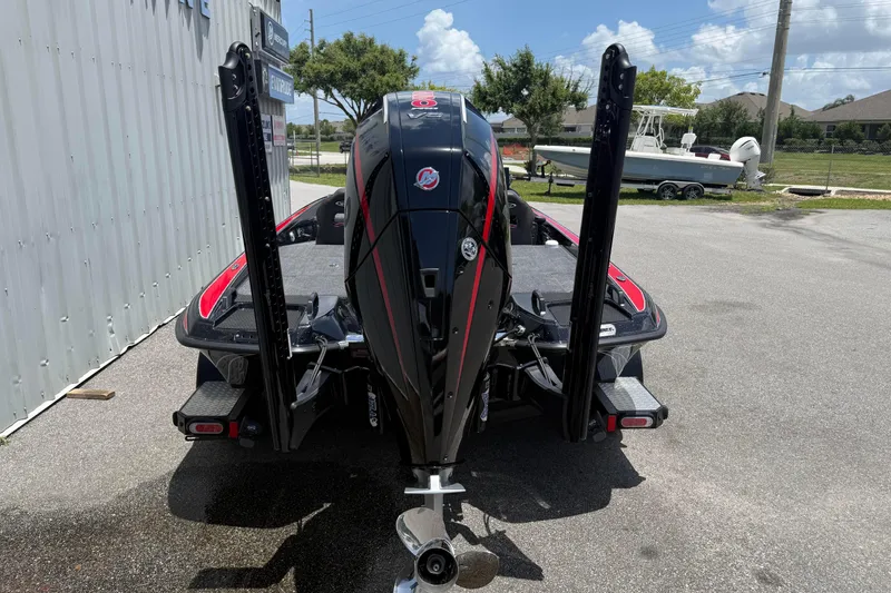 Slide: The Image of 2026 Phoenix 921 Elite X II boat, rear view, parked outdoors on a sunny day. - 12