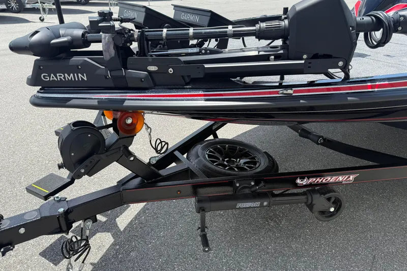 Slide: The Image of 2026 Phoenix 921 Elite X II boat trailer with Garmin equipment, parked on asphalt. - 15