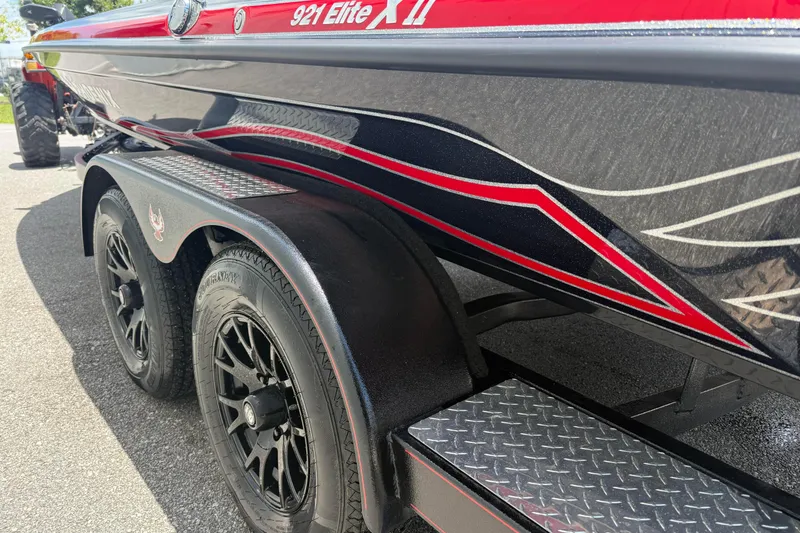 Slide: The Image of 2026 Phoenix 921 Elite X II boat trailer with stylish red and black design. - 4
