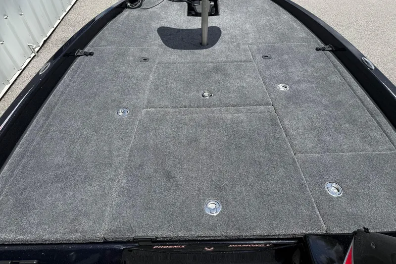 Slide: The Image of 2026 Phoenix 921 Elite X II boat deck with gray carpet and storage compartments. - 9