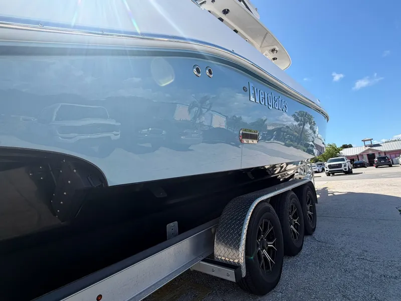 Slide: The Image of 2024 Everglades 335 Center Console boat on trailer outdoors. - 11