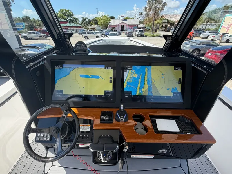 Slide: The Image of 2024 Everglades 335 Center Console dashboard with dual navigation screens. - 23