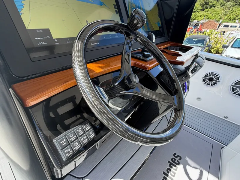 Slide: The Image of 2024 Everglades 335 Center Console helm with advanced controls and displays. - 27