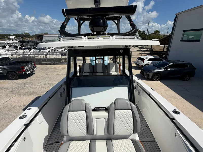 Slide: The Image of 2024 Everglades 335 Center Console boat in a parking lot. - 30