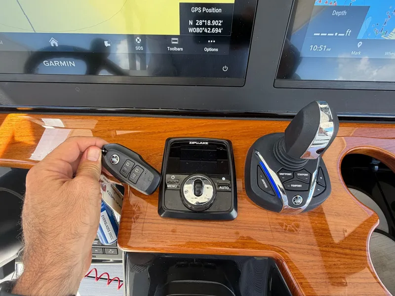 Slide: The Image of Everglades 335 Center Console 2024 dashboard with Garmin navigation. - 32
