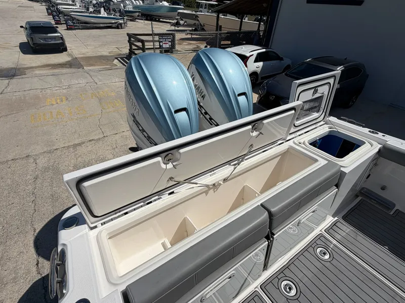 Slide: The Image of 2024 Everglades 335 Center Console with open storage and engines. - 35