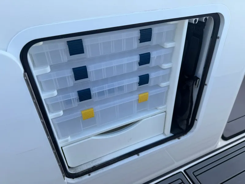 Slide: The Image of 2024 Everglades 335 Center Console, fishing gear storage. - 46