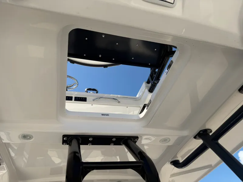 Slide: The Image of Interior view of Everglades 335 Center Console 2024 with open roof hatch. - 48