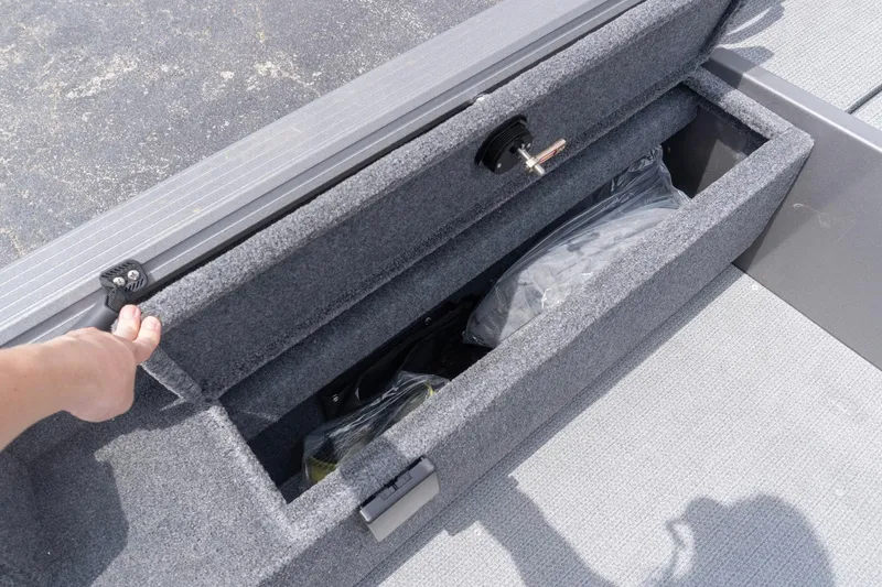 Slide: The Image of Storage compartment of 2026 G3 Angler V21 F boat, open with visible contents. - 21