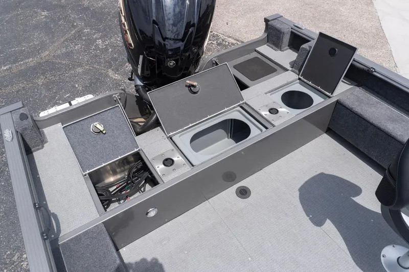 Slide: The Image of 2026 G3 Angler V21 F boat with open storage compartments and motor. - 24