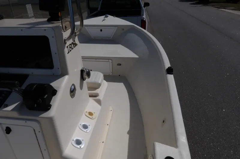 Slide: The Image of 2005 May-Craft 1800 Skiff boat interior, showing console and seating area. - 17