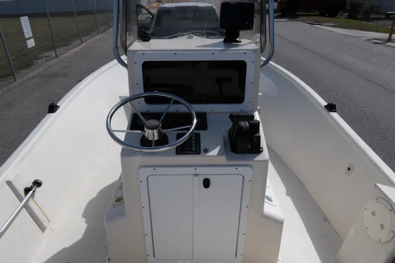 Slide: The Image of 2005 May-Craft 1800 Skiff boat console with steering wheel and controls. - 7