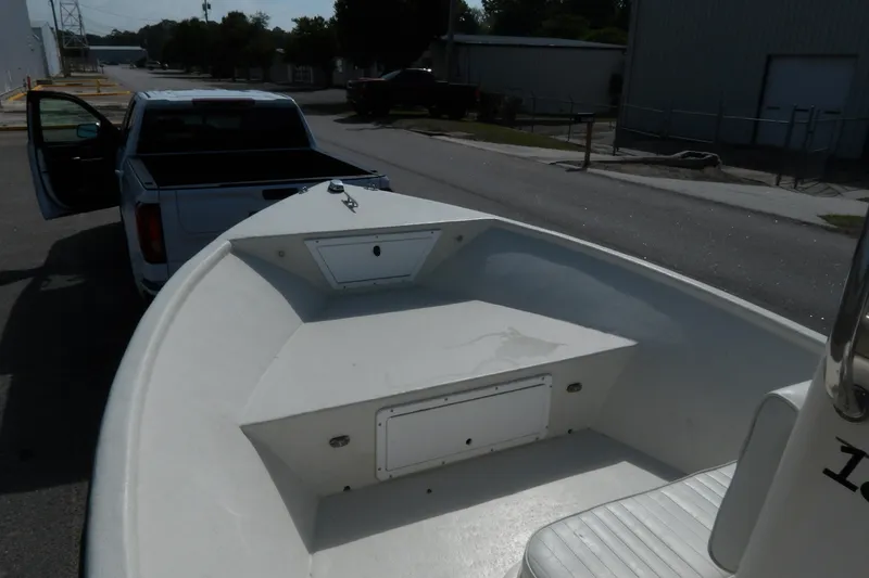 Slide: The Image of 2005 May-Craft 1800 Skiff boat on trailer, parked beside a white pickup truck. - 8