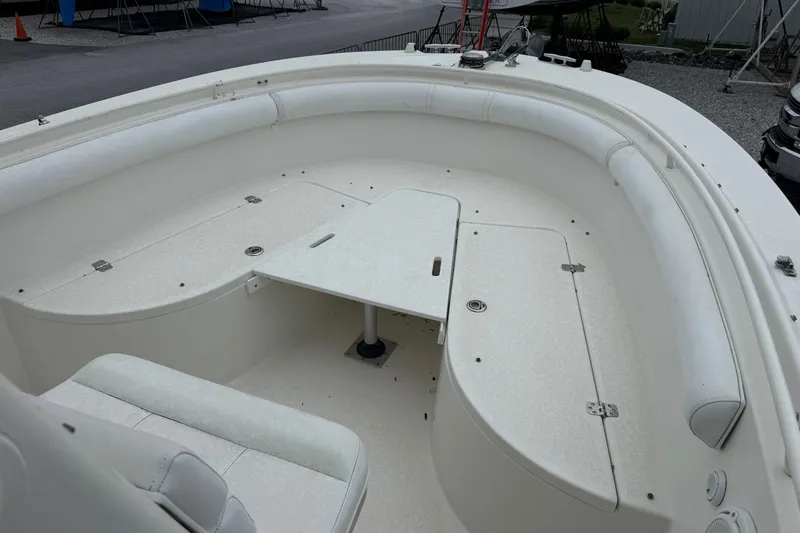 Slide: The Image of 2007 Edgewater 245CC boat interior with seating and table, showcasing spacious design. - 3