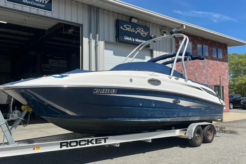 The Image of 2011 Sea Ray 260 Sundeck boat on trailer outside marine service center. - 1