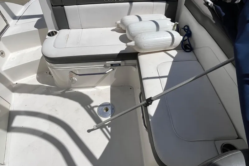 Slide: The Image of 2011 Sea Ray 260 Sundeck interior with seating and boat fenders. - 10