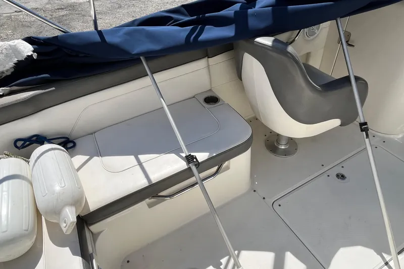 Slide: The Image of 2011 Sea Ray 260 Sundeck interior with seating and boat accessories. - 11