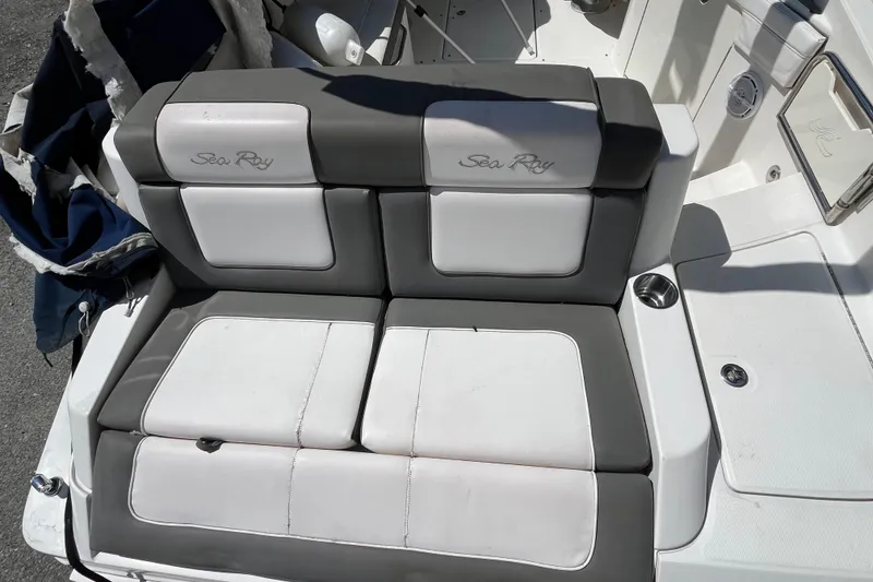 Slide: The Image of 2011 Sea Ray 260 Sundeck boat seating with gray and white upholstery. - 12