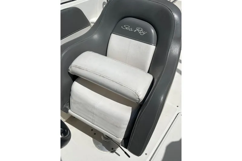 Slide: The Image of Captain's seat of a 2011 Sea Ray 260 Sundeck boat, featuring gray and white upholstery. - 15