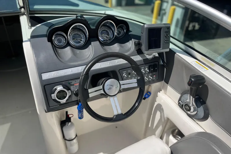 Slide: The Image of 2011 Sea Ray 260 Sundeck dashboard with steering wheel, gauges, and Garmin navigation system. - 16