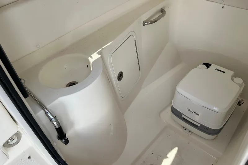 Slide: The Image of Interior of 2011 Sea Ray 260 Sundeck with sink and portable toilet. - 22