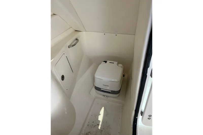Slide: The Image of Interior of 2011 Sea Ray 260 Sundeck featuring a compact marine toilet. - 23