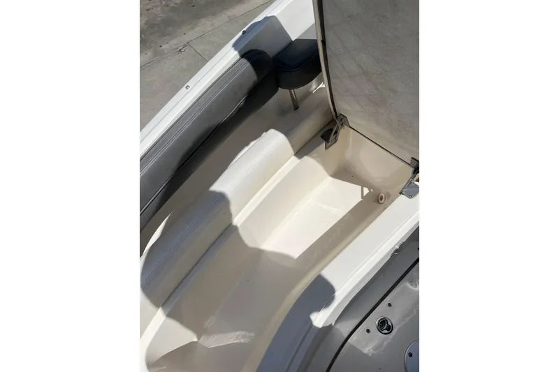 Slide: The Image of 2011 Sea Ray 260 Sundeck interior seating and storage compartment. - 26