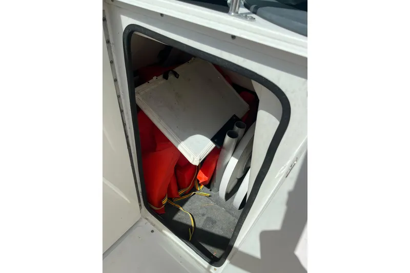 Slide: The Image of Storage compartment on a 2011 Sea Ray 260 Sundeck boat with life jackets and equipment. - 28