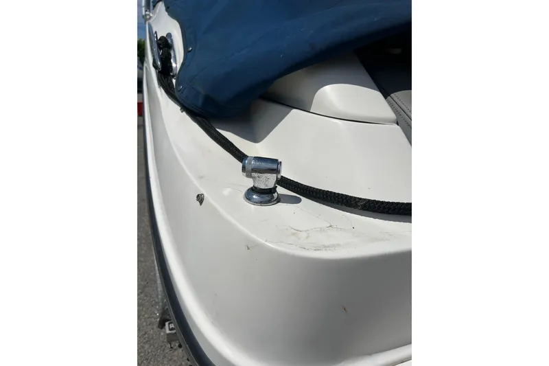Slide: The Image of 2011 Sea Ray 260 Sundeck boat with blue cover and cleat detail. - 30