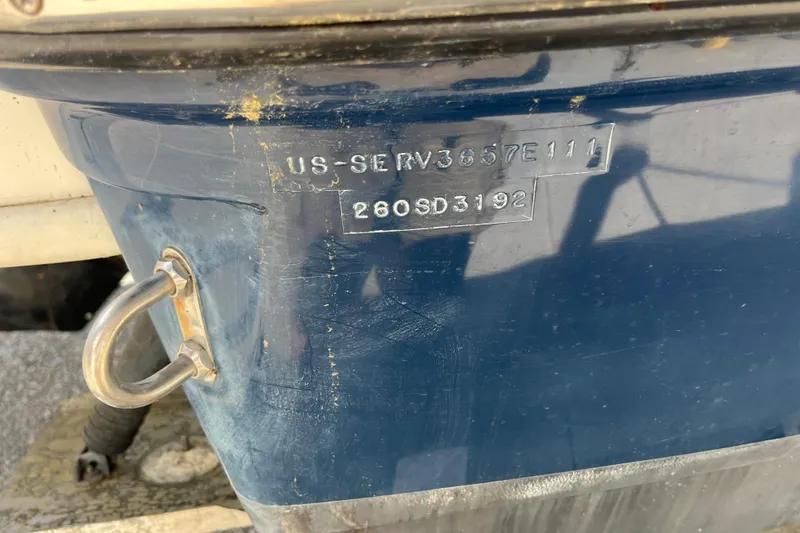 Slide: The Image of 2011 Sea Ray 260 Sundeck hull identification number on blue boat exterior. - 36