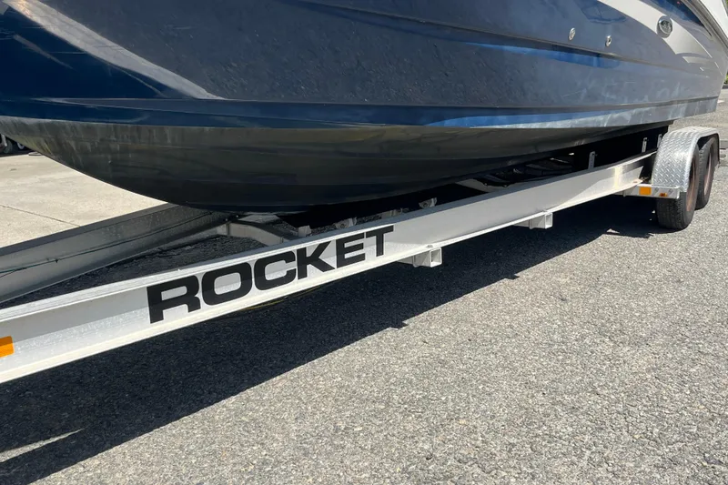 Slide: The Image of 2011 Sea Ray 260 Sundeck on a Rocket trailer, parked on asphalt. - 37