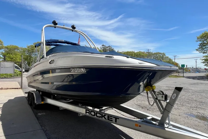 Slide: The Image of 2011 Sea Ray 260 Sundeck boat on trailer under clear blue sky. - 4