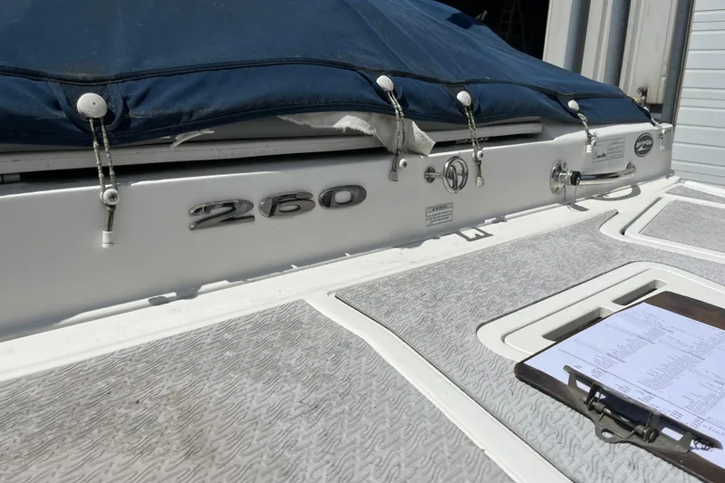 Slide: The Image of 2011 Sea Ray 260 Sundeck boat with covered deck and visible clipboard. - 5