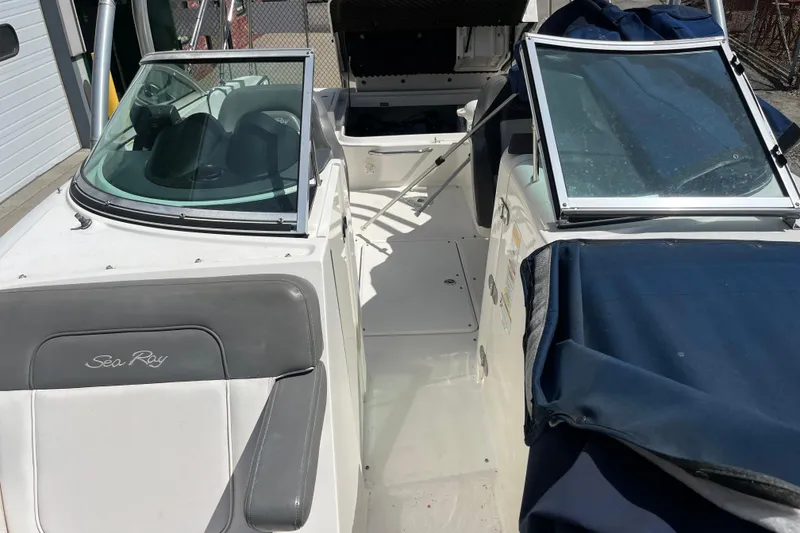 Slide: The Image of 2011 Sea Ray 260 Sundeck boat interior with open windshield and seating area. - 8