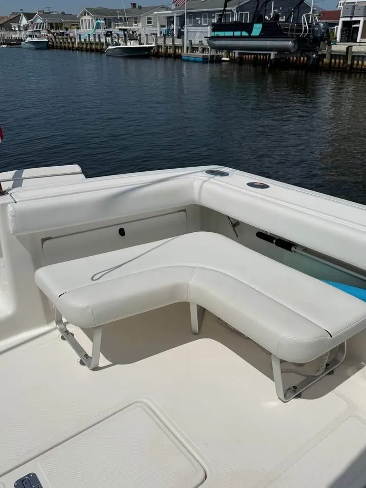Slide: The Image of 1999 Tiara Yachts 2900 Coronet with white seating by the water. - 10