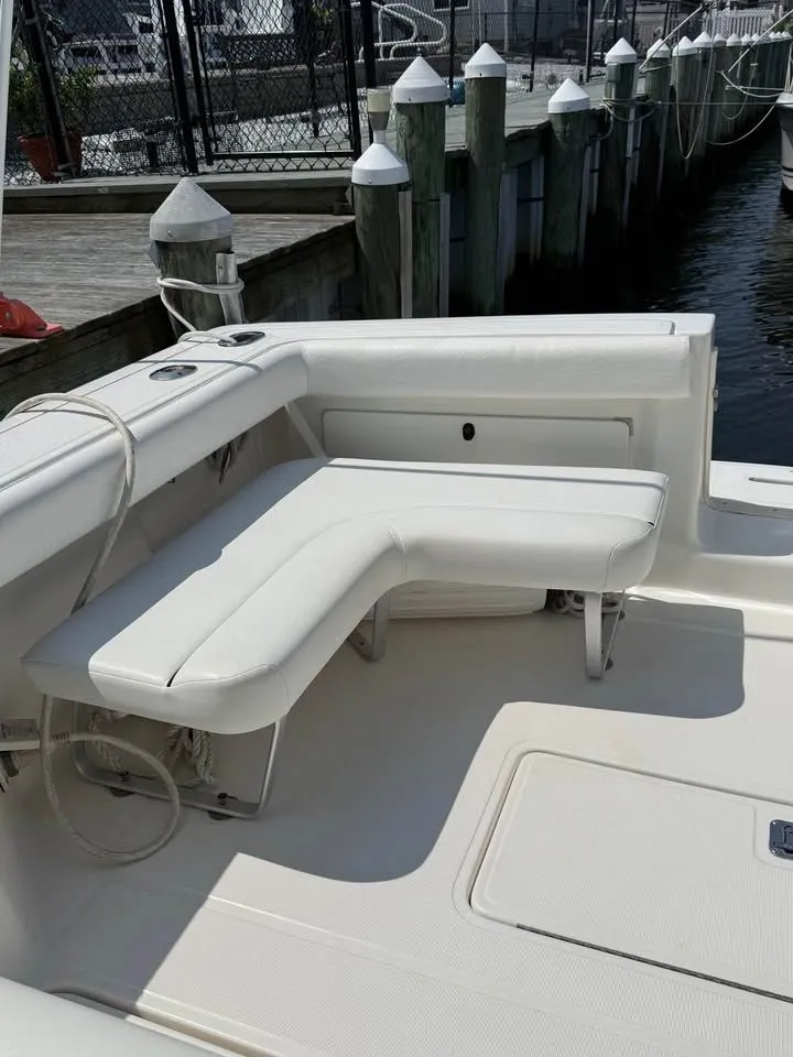 Slide: The Image of 1999 Tiara Yachts 2900 Coronet with white seating area at dock. - 9