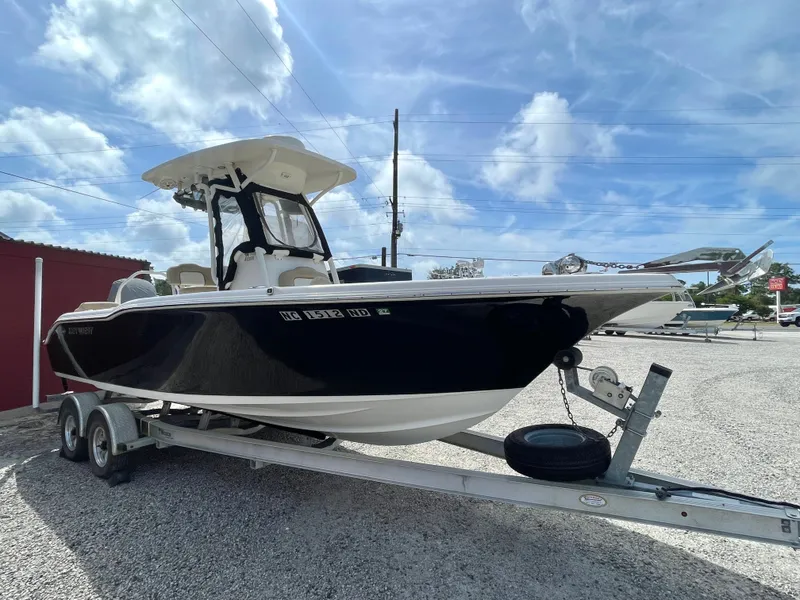 Slide: The Image of 2017 Key West 239 FS boat on trailer under blue sky. - 11