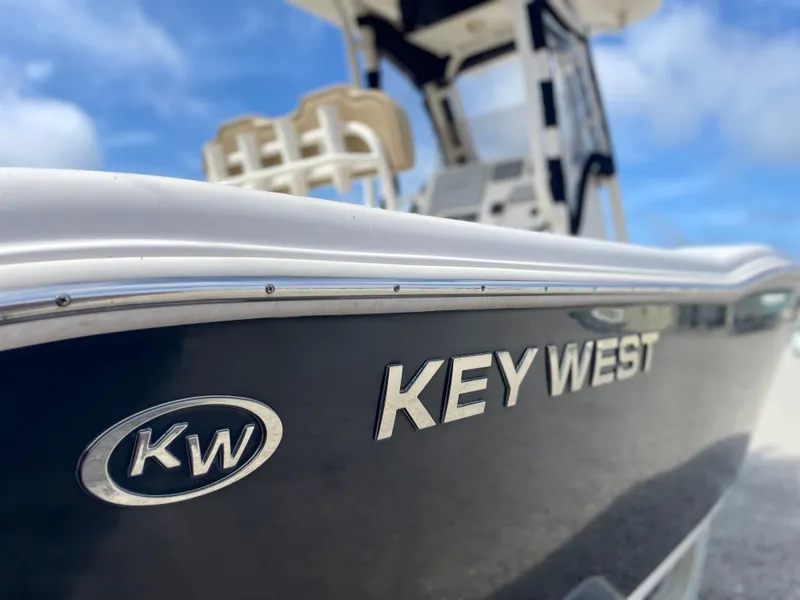 Slide: The Image of Close-up of a 2017 Key West 239 FS boat under blue sky. - 47