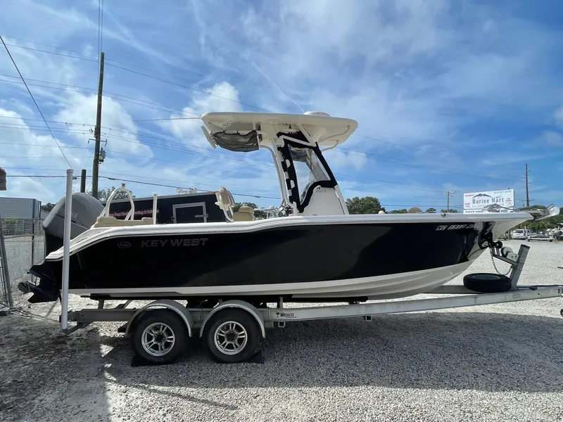 Slide: The Image of 2017 Key West 239 FS boat on trailer, blue sky. - 9