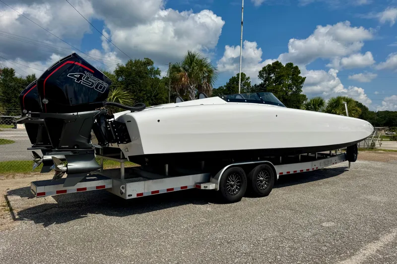 Slide: The Image of 2024 Fountain 34 Thundercat boat on trailer, featuring powerful outboard engines. - 1