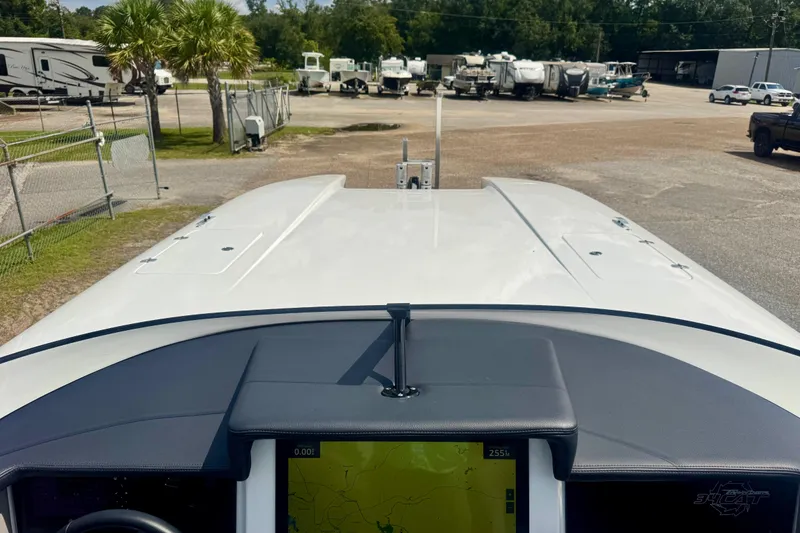 Slide: The Image of 2024 Fountain 34 Thundercat boat dashboard with navigation screen, parked in a lot. - 12